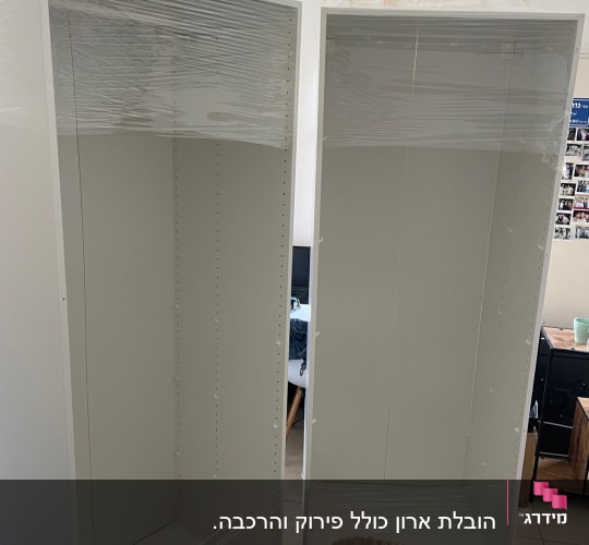 ארונות עטופים בניילון בחדר עם מזגן על הקיר